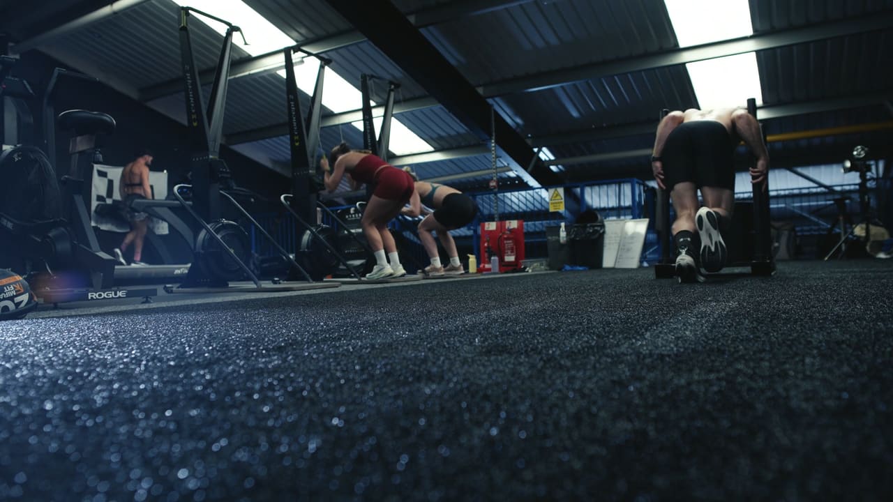 Wide view of a gym floor mid-race with athletes at every station
